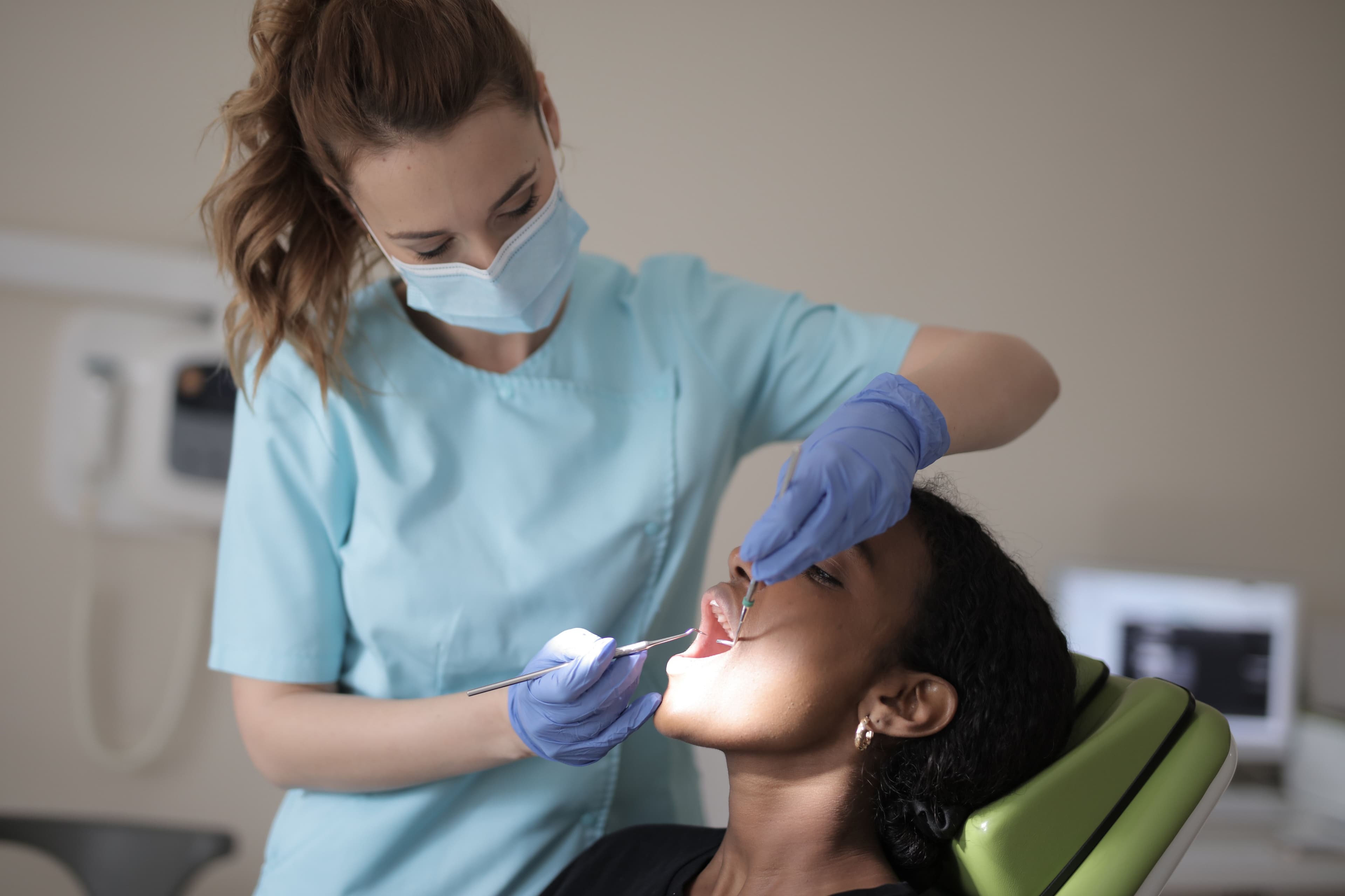 Dentist assessing a patient with severe tooth pain